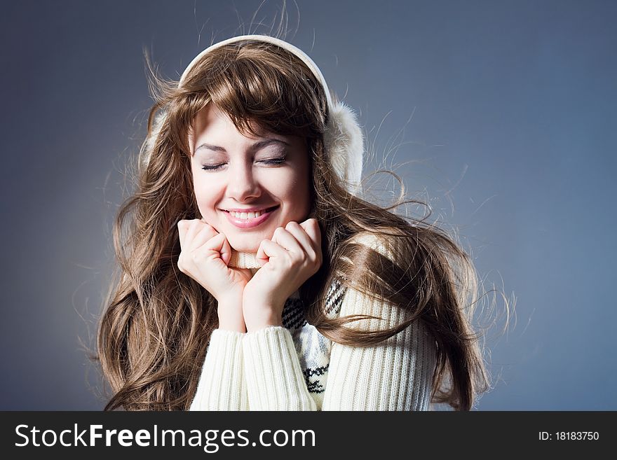 Young beautiful girl rejoices to snow, On a dark blue background