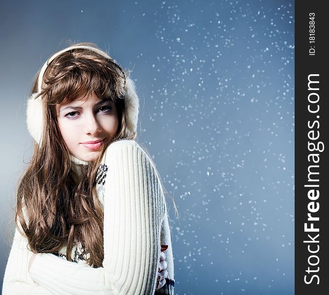 Young beautiful girl rejoices to snow, On a dark blue background