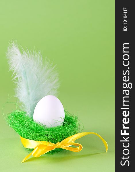 Easter egg in basket with ribbon and copy space. Easter egg in basket with ribbon and copy space