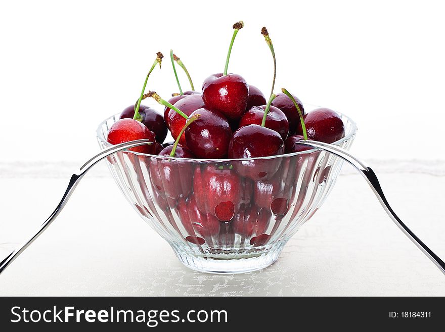 A bowl of fresh cherry with two fruit fork for couple. A bowl of fresh cherry with two fruit fork for couple.