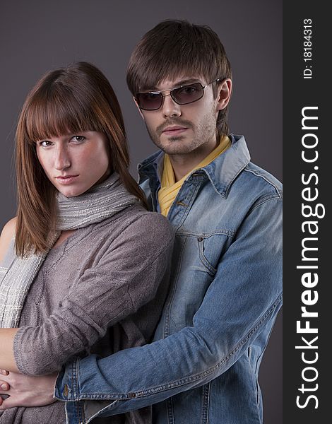 Portrait of fashionable couple posing in studio. Portrait of fashionable couple posing in studio