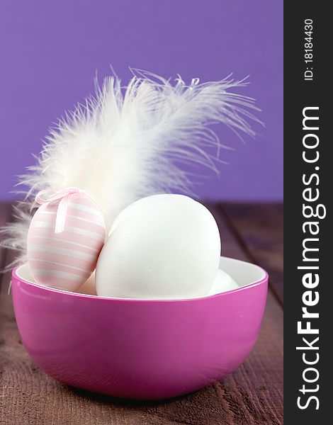 Easter eggs in a bowl with feather