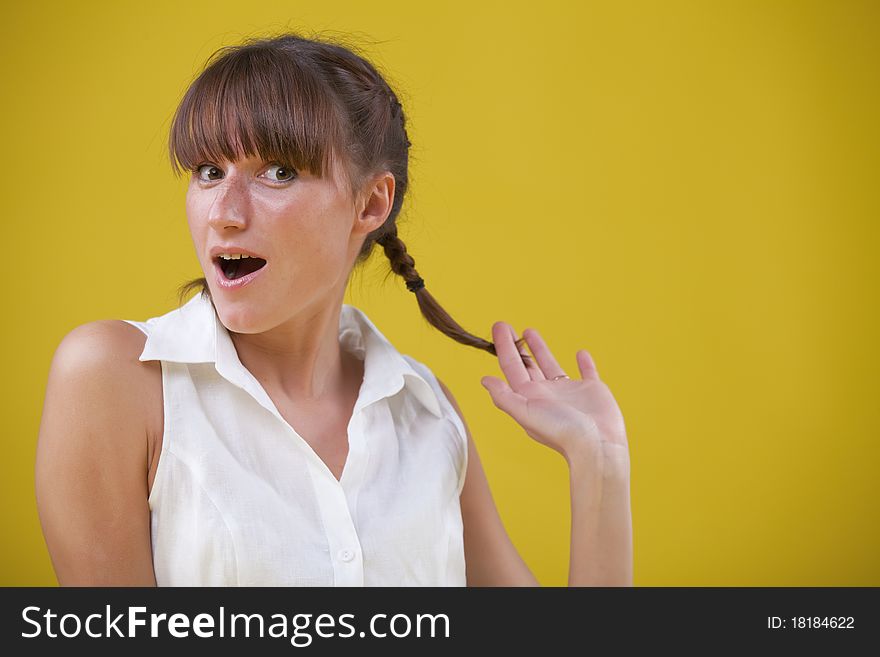 Innocent woman with face expression over yellow background