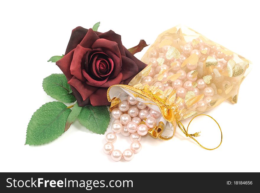 Pearl necklace and roses on a white background. Pearl necklace and roses on a white background