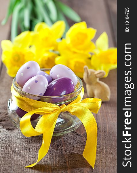 Easter eggs in a bowl with ribbon and daffodils. Easter eggs in a bowl with ribbon and daffodils