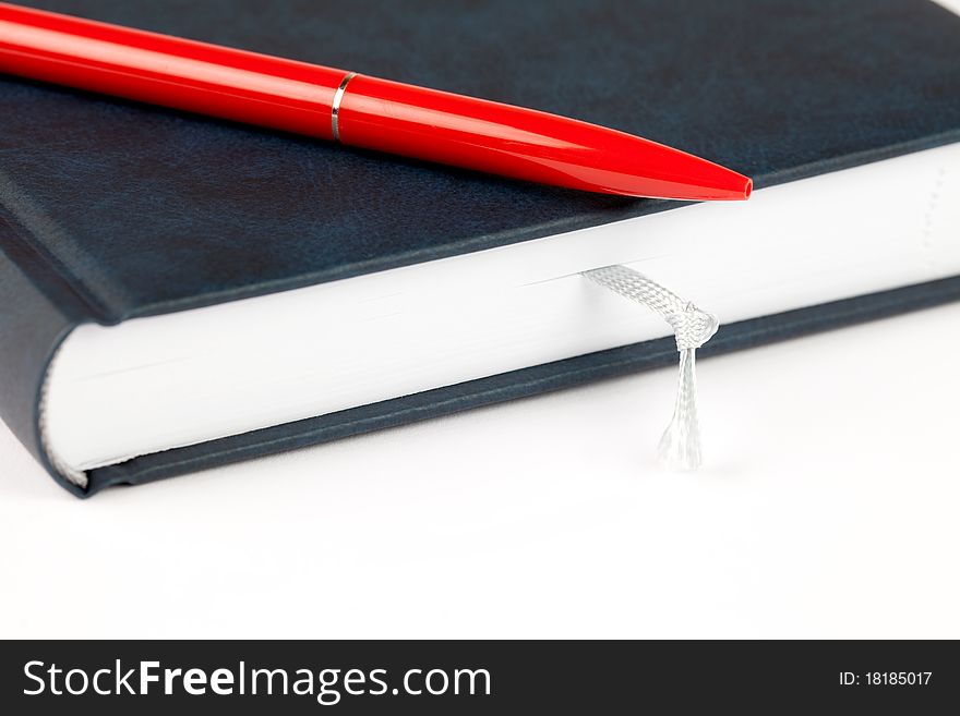 Organizer with node and red pen isolated on white background. Organizer with node and red pen isolated on white background