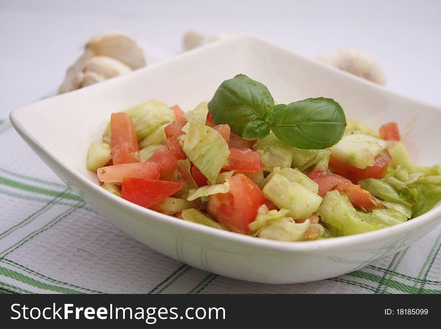 A fresh salad of iceberg salad, tomatoes and Cucumbers