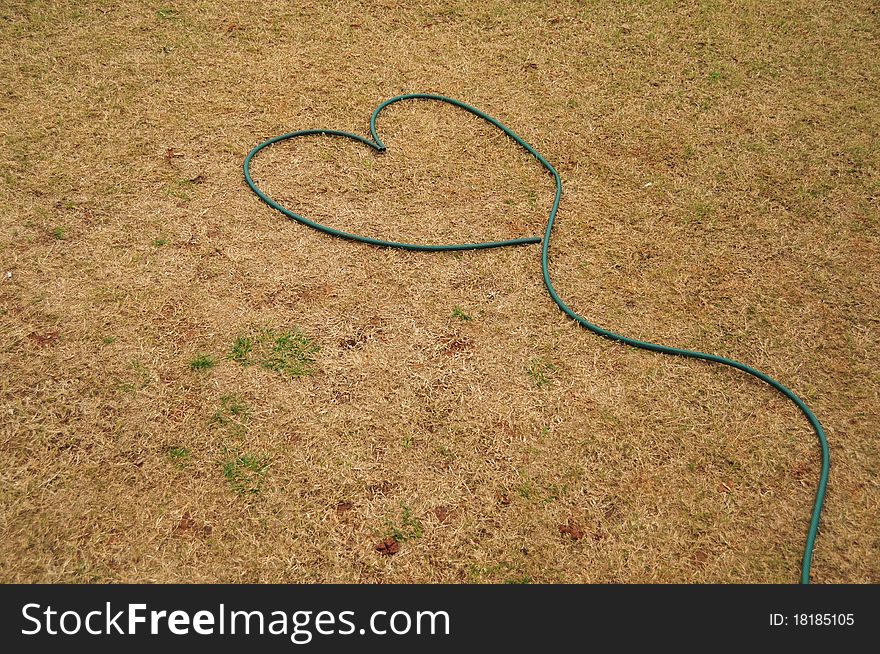 Heart made of hose in a garden. Heart made of hose in a garden