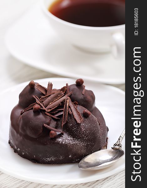 Delicious chocolate cake with coffee on a white plate