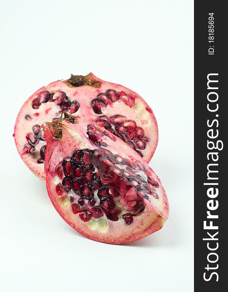 Sliced pomegranate isolated on white background