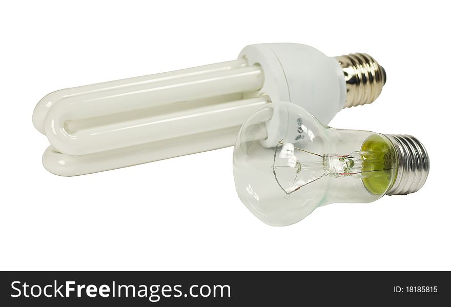 Incandescent lamp and fluorescent lamp on a white background, close-up. Incandescent lamp and fluorescent lamp on a white background, close-up