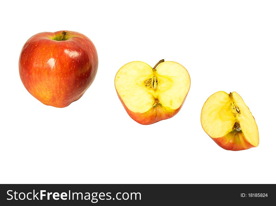 A whole apple, half and quartered apples isolated on a white background. A whole apple, half and quartered apples isolated on a white background.