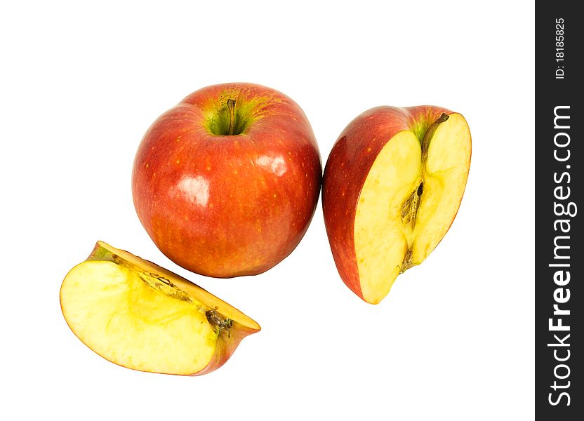 A whole apple, half and quartered apples isolated on a white background. A whole apple, half and quartered apples isolated on a white background.