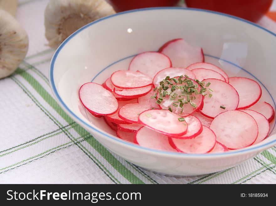 A fresh salad of red radish in a bowl