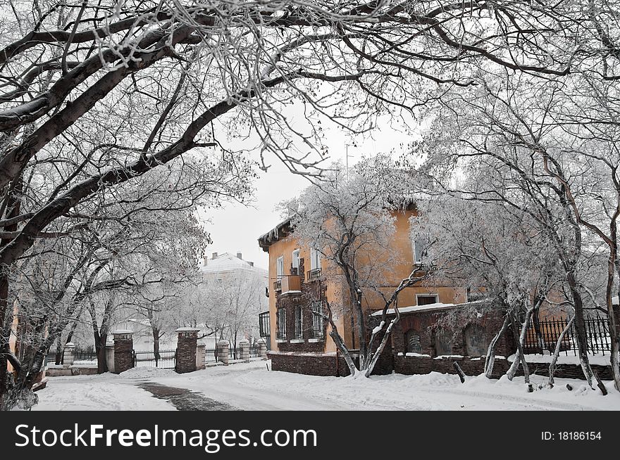 House on the snow-covered lane among trees. House on the snow-covered lane among trees