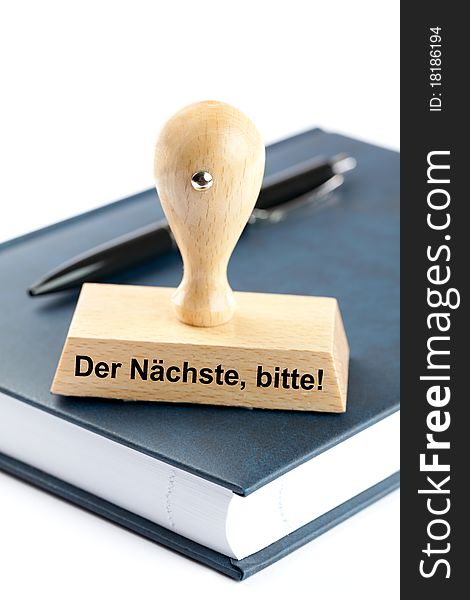 Rubber stamp with german text on organizer isolated on white background. Rubber stamp with german text on organizer isolated on white background