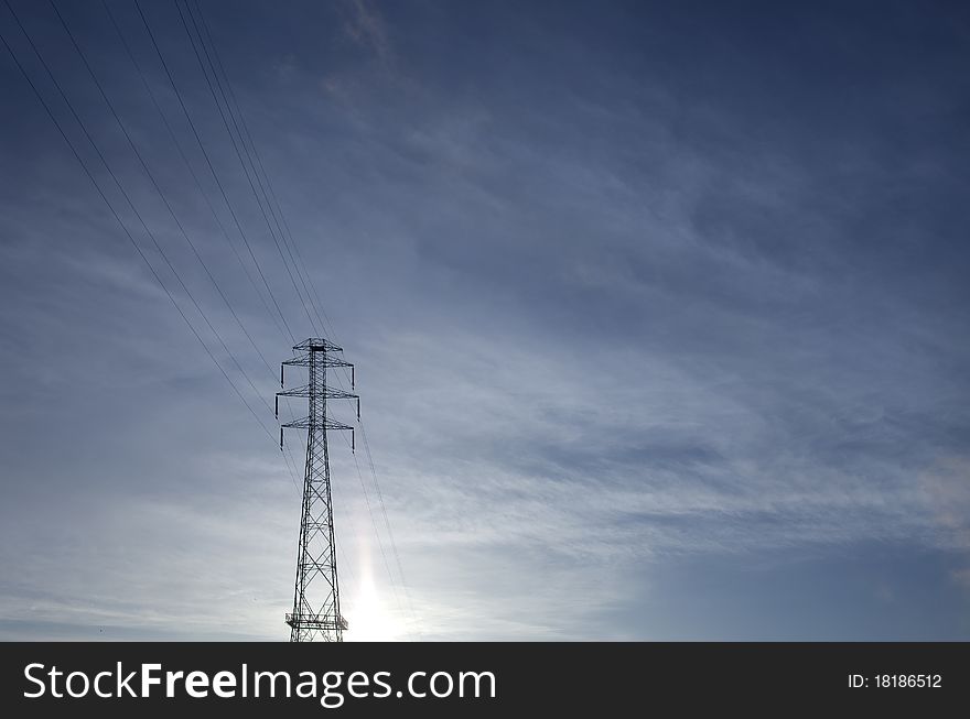 Power lines against blue sky