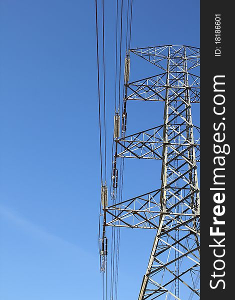 big electricity post with blue sky