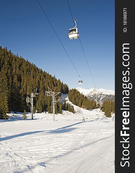 Cable car lift over a ski slope through the trees. Cable car lift over a ski slope through the trees