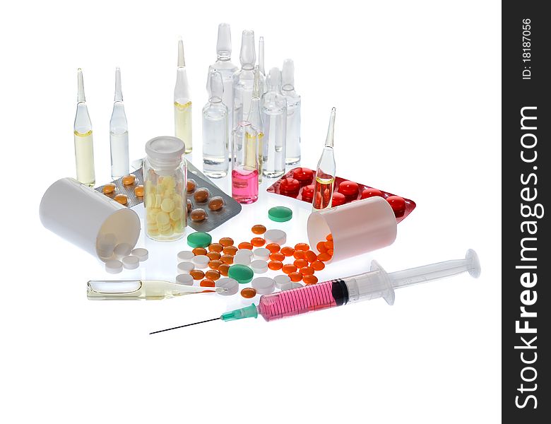 A lot of colorful pills and ampoules on white background. A lot of colorful pills and ampoules on white background