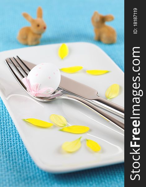 Blue place setting with petals and bunnies. Blue place setting with petals and bunnies