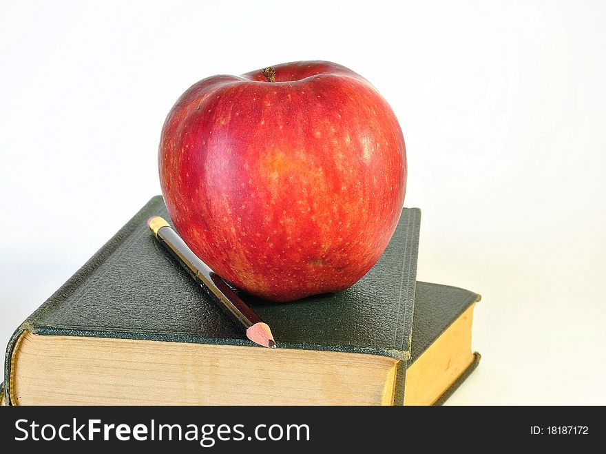 Two old books with a ripe,red apple. Two old books with a ripe,red apple
