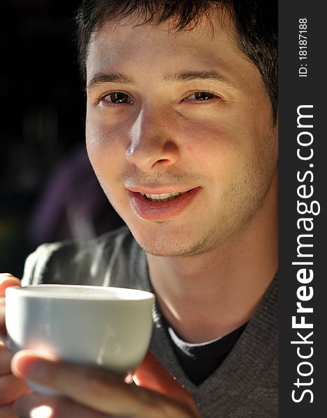 Young man enjoying cup of coffee. Young man enjoying cup of coffee