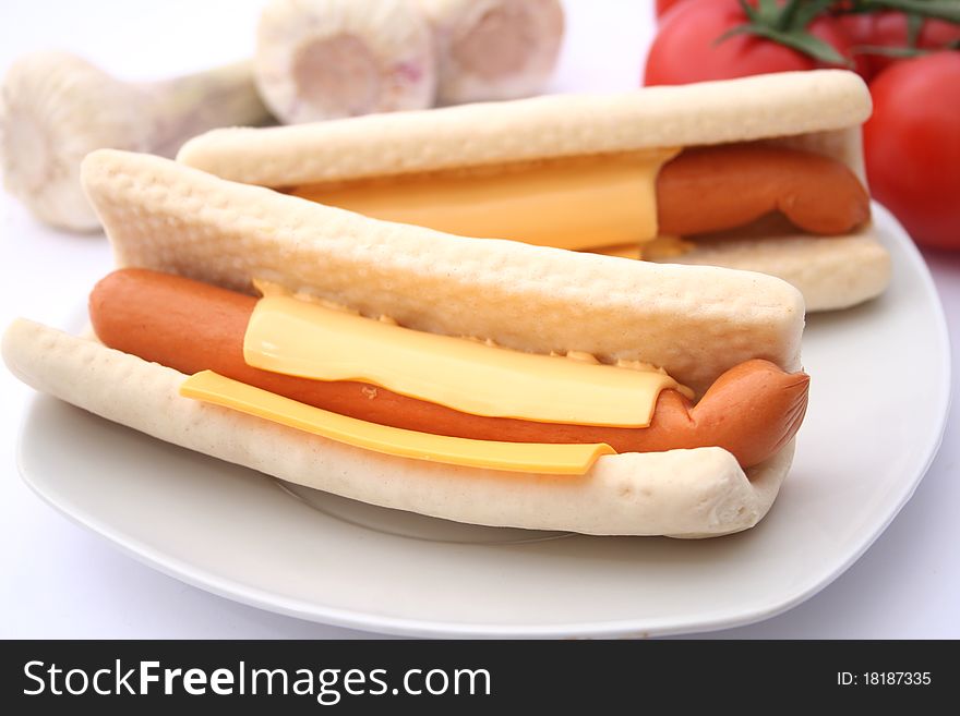 Two fresh hot dogs with cheese