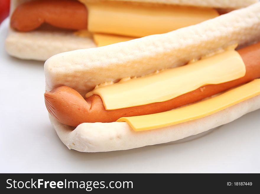 Two fresh hot dogs with cheese