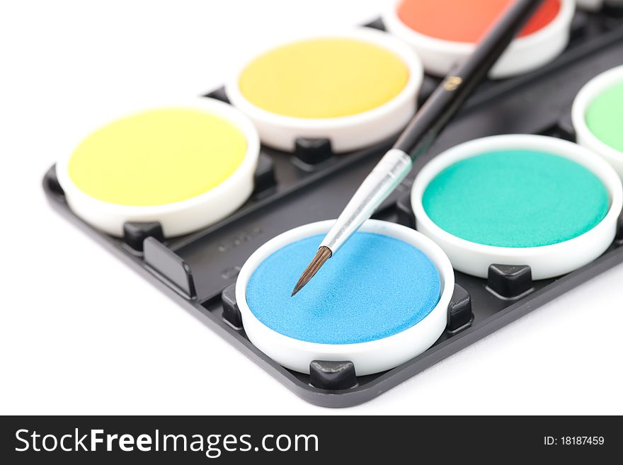 Colors on a palette with brush isolated on white