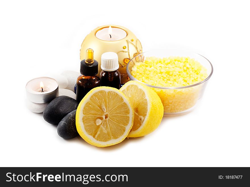 Candles, lemon and sea salt with stones isolated on white background. Candles, lemon and sea salt with stones isolated on white background