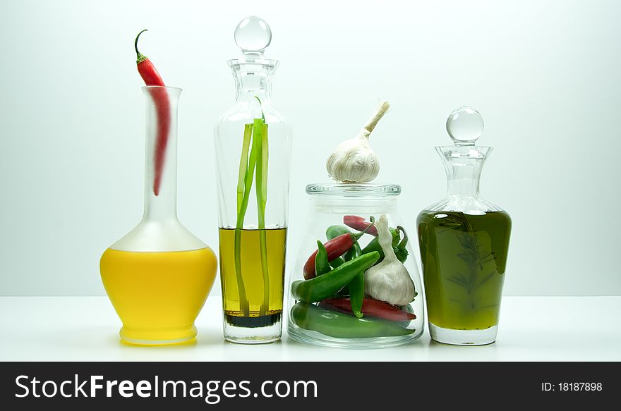 Decorative bottles with oil and vegetables
