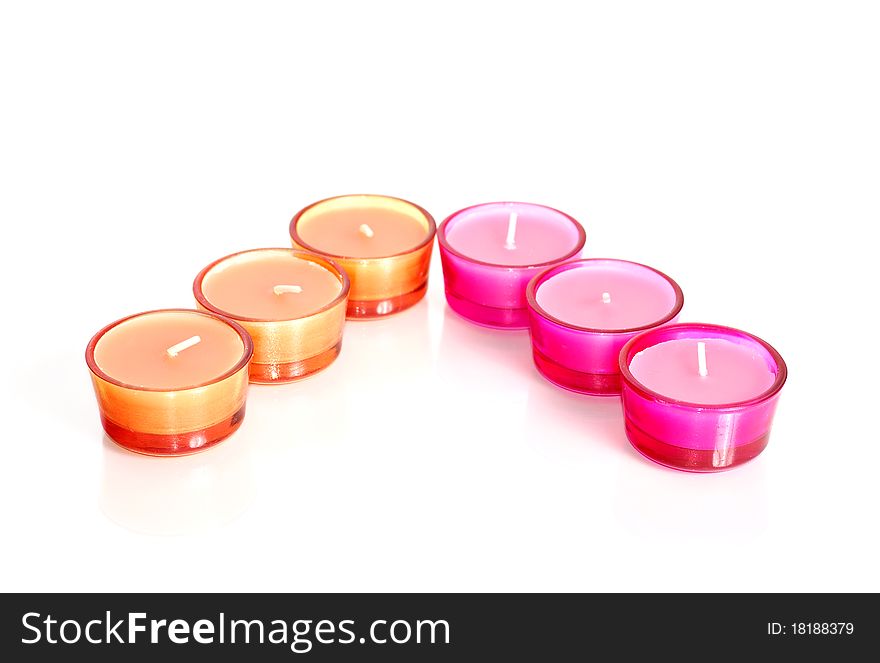 Pink and orange candles in glass isolated on white. Pink and orange candles in glass isolated on white.