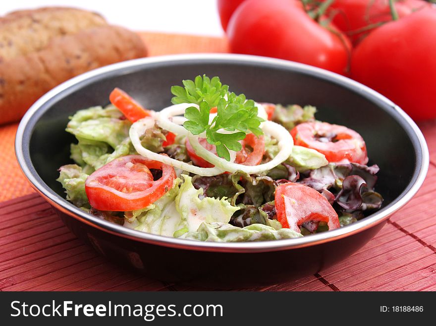 Fresh salad with tomatoes in a bowl
