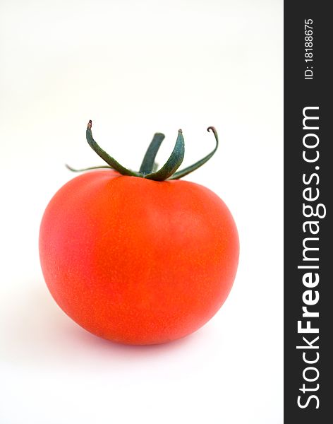 Ripe red tomato at the white background