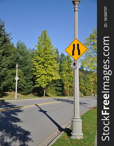 Road narrow sign with nature view