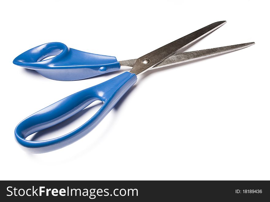 Blue metal scissors over white background. Studio shot.