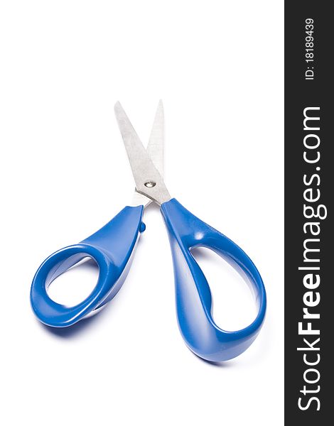 Blue metal scissors over white background. Studio shot.