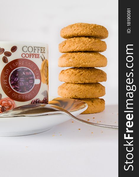 Coffee cup with teaspoon and cookies on white background. Coffee cup with teaspoon and cookies on white background