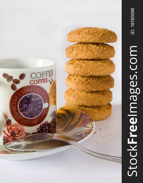 Coffee cup with teaspoon and cookies on white background. Coffee cup with teaspoon and cookies on white background