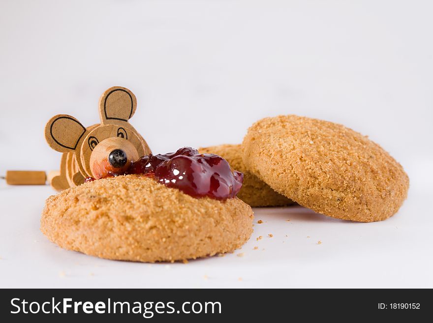 Mouse toy eat jam on cookie. Mouse toy eat jam on cookie