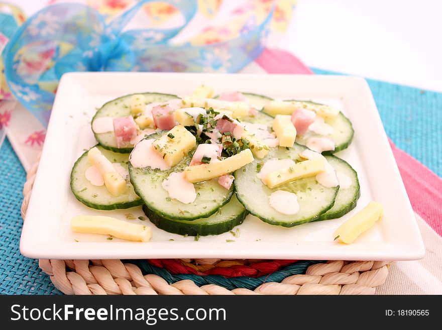 A fresh salad of cucumbers with ham and cheese