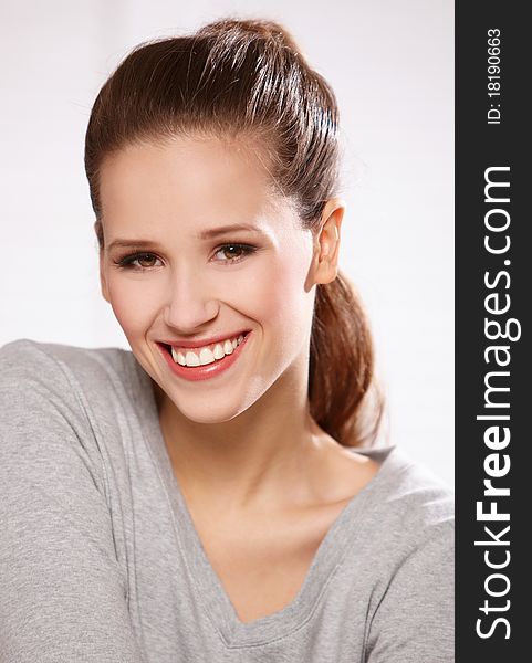 Closeup portrait of a happy young woman smiling. Closeup portrait of a happy young woman smiling