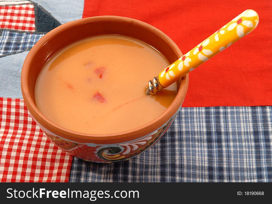 Bowl of tomato soup on table tablecloth