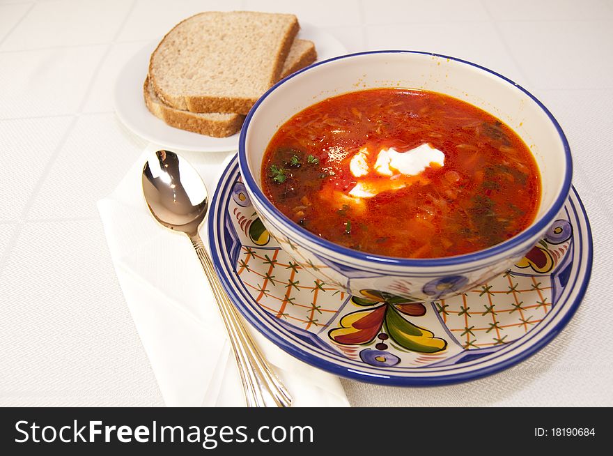 Vegetable soup in bowl with sour cream