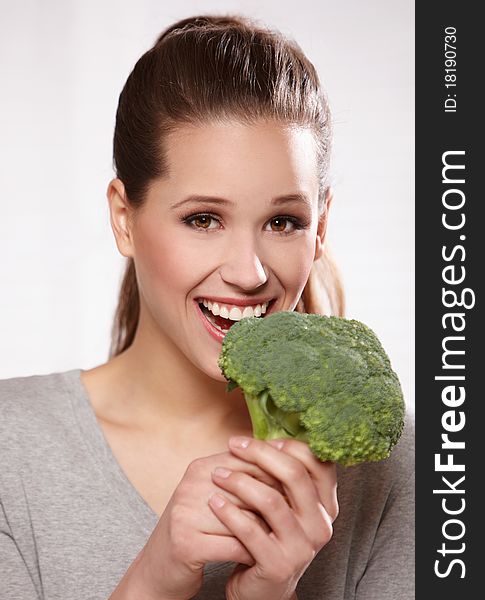 Portrait of a beautiful smiling woman with broccoli, isolated on white. Portrait of a beautiful smiling woman with broccoli, isolated on white