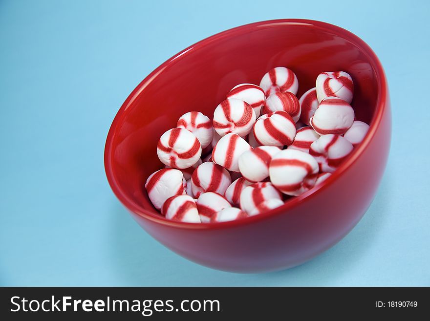 Peppermint candies shot on red plate. Plenty of space for copy and design elements. Peppermint candies shot on red plate. Plenty of space for copy and design elements.