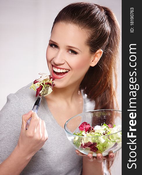 Portrait of young happy woman eating salad. Portrait of young happy woman eating salad