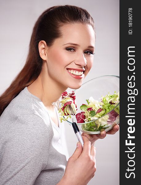 Portrait of young happy woman eating salad. Portrait of young happy woman eating salad