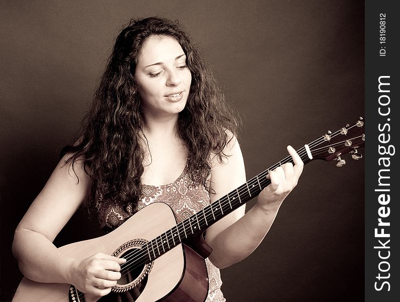 Casual woman playing the guitar